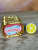 Close-up of classic sardine clicker keychain and lemon charm