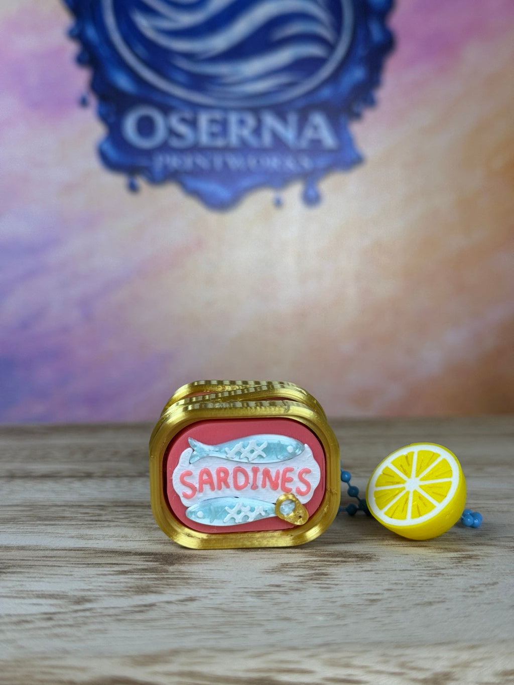 Classic sardine clicker keychain with lemon charm, front view