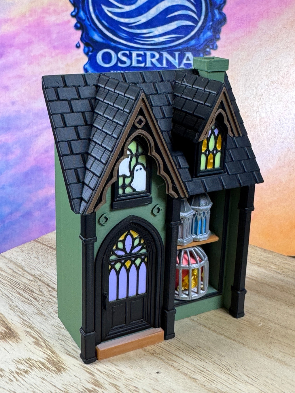 Green Spooky House Lantern Multi-Clicker with black gothic roof, ghost stained-glass windows and colorful lanterns